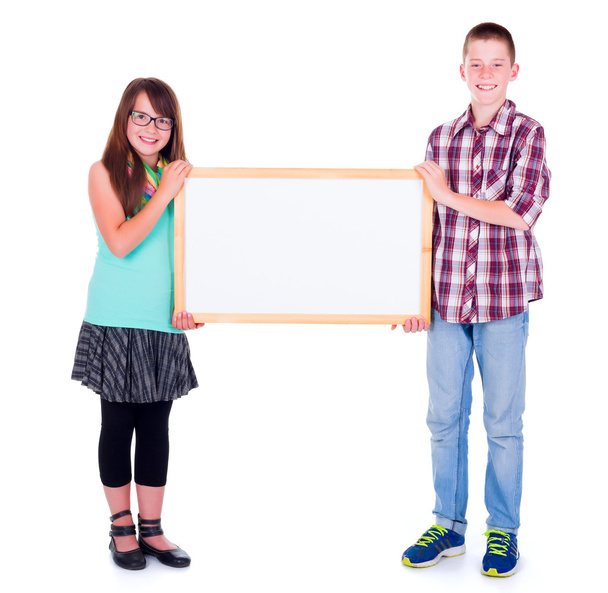 Boy and girl holding an empty advertising board - Фото, изображение