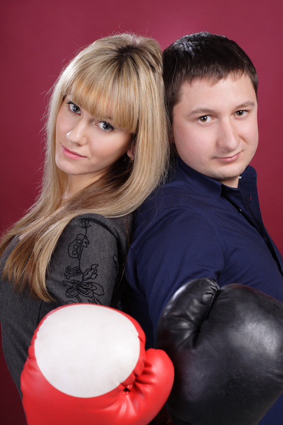 Attractive family couple in boxing gloves on red - Fotó, kép