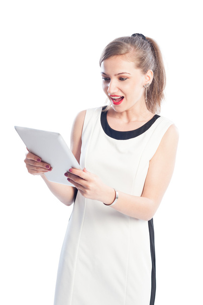 Excited woman holding and looking at tablet - Photo, Image