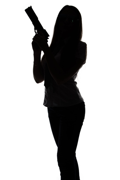 Silhouette de jeune espion femme avec arme
 - Photo, image