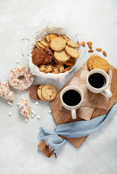 Cookies assortment on light background. Homemade desserts. Celebration concept. Top view, flat lay - 写真・画像