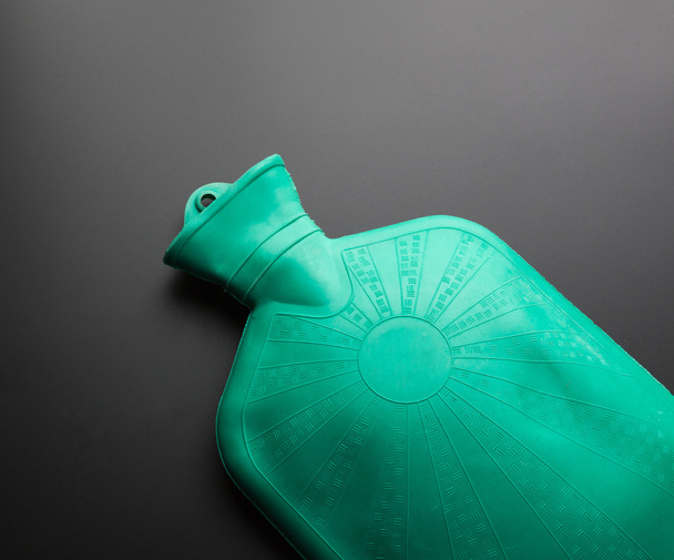 Botella de agua caliente de caucho verde
 - Foto, imagen