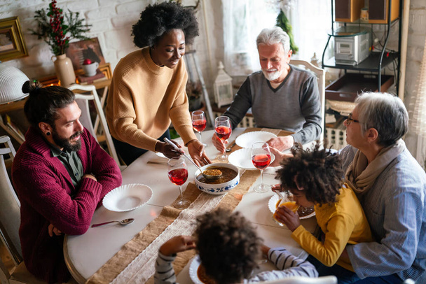 Happy multiethnic family having a holiday dinner together. People love generation concept - Φωτογραφία, εικόνα
