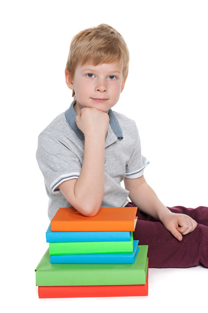 Serious young boy near books - Zdjęcie, obraz