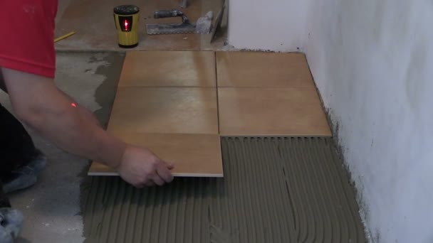 Home improvement, renovation - handyman lay tile on room floor - Footage, Video