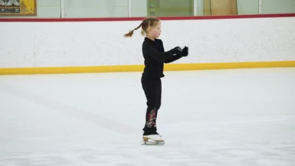 Pequeña patinadora practicando sus elementos en la práctica de patinaje artístico matutino. - Imágenes, Vídeo