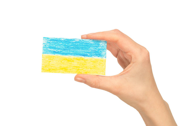 Ukrainian flag in woman hands isolated on a white background. Stop war.  - Photo, Image