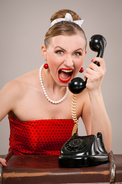 Woman shouting into telephone - Foto, Imagen