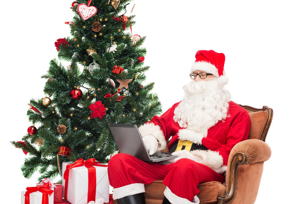 man in costume of santa claus with laptop - Foto, Imagen