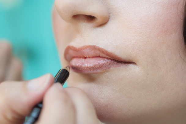 Closeup of woman applying lipstick - Фото, зображення