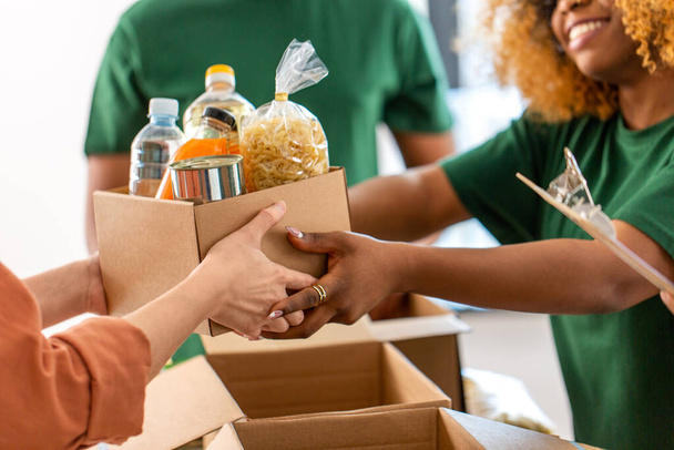 volunteers give food at refugee assistance center - Photo, Image