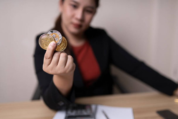 business woman holding bitcoins, Ethereum and Ripple, concept cryptocurrency exchange. technology and investment digital. finance, Trader, investor, gold Bitcoin Cash, collect money - 写真・画像