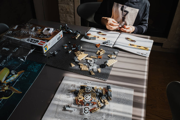 21.03.2022. Batumi, Georgia. Menino criança dobra manualmente Lego construtor na mesa.. Star Wars. Disney - Foto, Imagem
