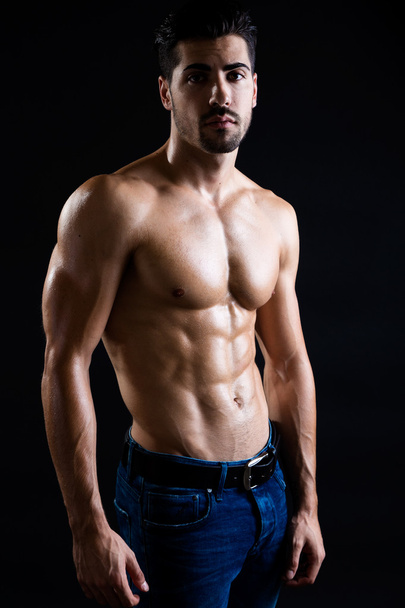 Beautiful and muscular man in dark background.  - Foto, immagini