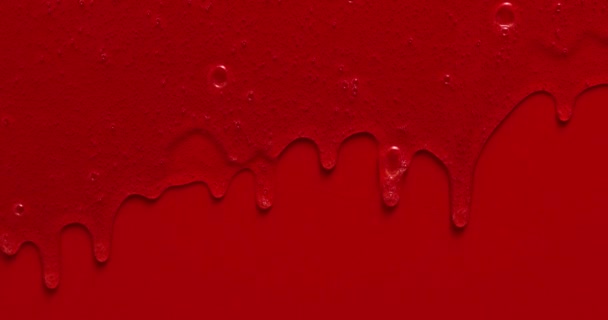 Cream liquid gel serum flows down red silver texture, makeup and cosmetics background, skincare or hair product - Footage, Video
