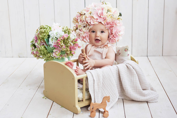 Baby girl in flower hat. Postcard Mother's Day and Easter. Children Protection Day. World Happiness Day. Smiling child. - Fotó, kép