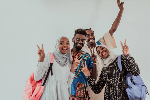 Group of happy african students having conversation and team meeting working together on homework girls wearing traidiional sudan muslim hijab fashion - Fotó, kép