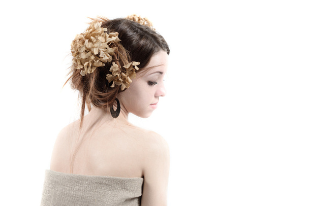 Jonge vrouw in landelijke stijl met vlas en gedroogde bloemen - Foto, afbeelding
