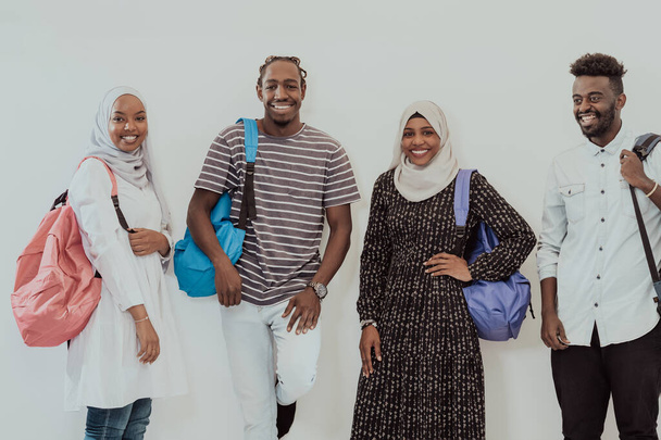 Photo of a group of happy african students talking and meeting together working on homework girls wearing traditional Sudanese Muslim hijab - Fotografie, Obrázek