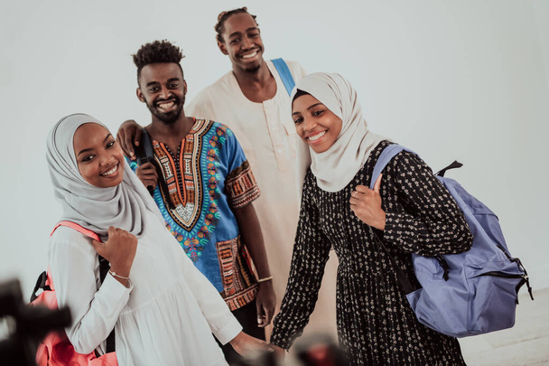 Group of happy african students having conversation and team meeting working together on homework girls wearing traidiional sudan muslim hijab fashion - Photo, Image