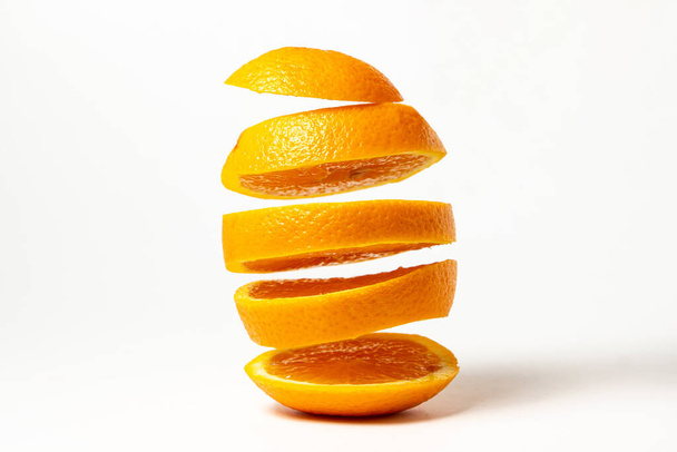 Sliced orange isolated on white background. Orange cut into round slices. Ripe citrus fruit - Photo, Image