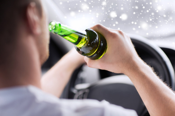 close up of man drinking alcohol while driving car - 写真・画像