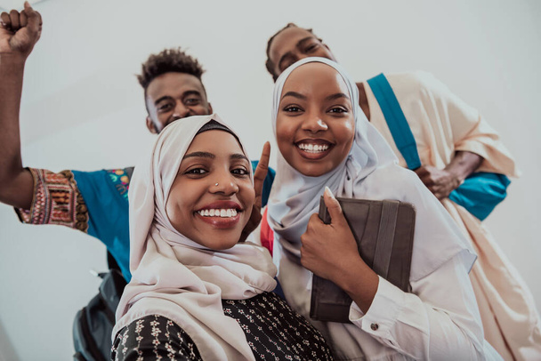 A group of multiethnic students take a selfie with a smartphone on a white background. Selective focus  - Photo, Image