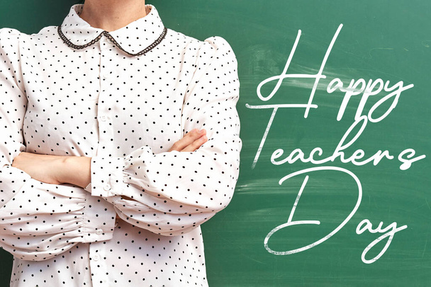 A young teacher posing over chalkboard - Happy teachers day conc - Photo, Image
