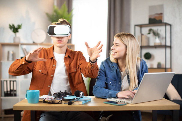 Excited young people using VR glasses for having fun at home - Foto, Bild
