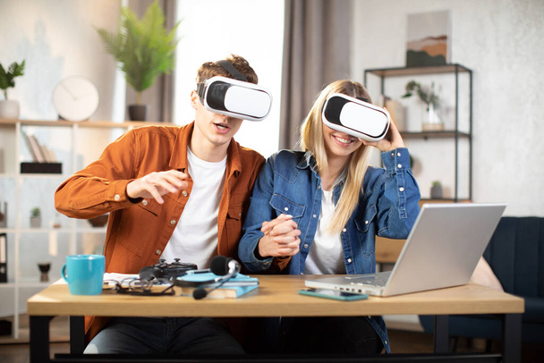 Excited family using VR glasses for playing games at home - Photo, Image