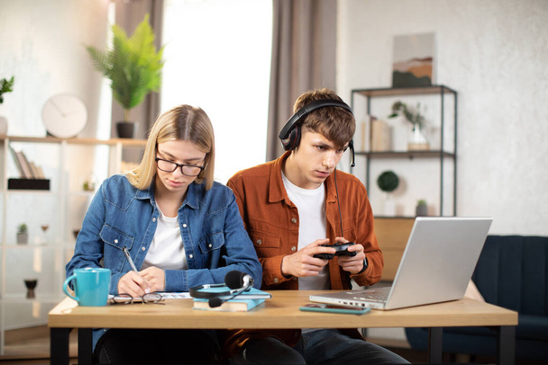 Teenagers playing video games at home - Fotó, kép