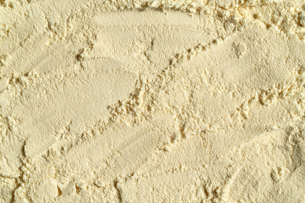 Beige πρωτεΐνη ορού γάλακτος σε σκόνη φόντο με αντίγραφο χώρο - Φωτογραφία, εικόνα