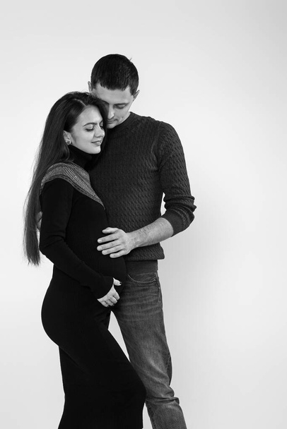 Husband hugs pregnant wife and touching belly - Фото, изображение