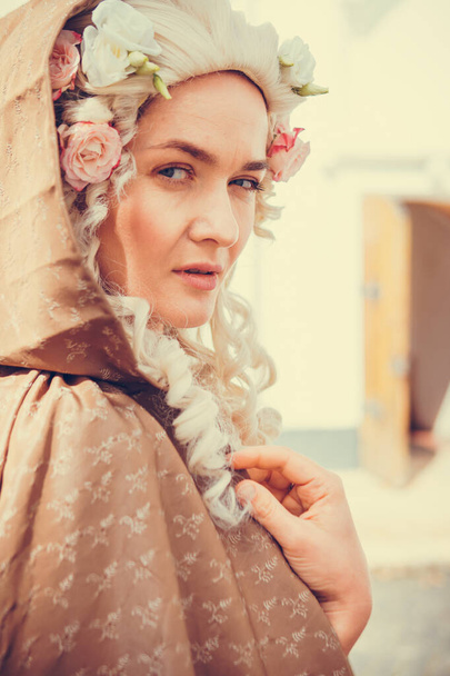 Portrait of blonde woman dressed in historical Baroque clothes with old fashion hairstyle, outdoors. Luxurious medieval dress - Valokuva, kuva