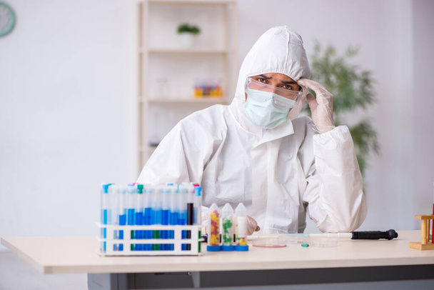 Young male chemist in drugs synthesis concept - Photo, Image