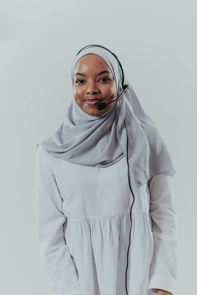 African muslim female with hijab scarf customer representative business woman with phone headset helping and supporting online with customer in modern bright call centre isolated on white background - Фото, изображение