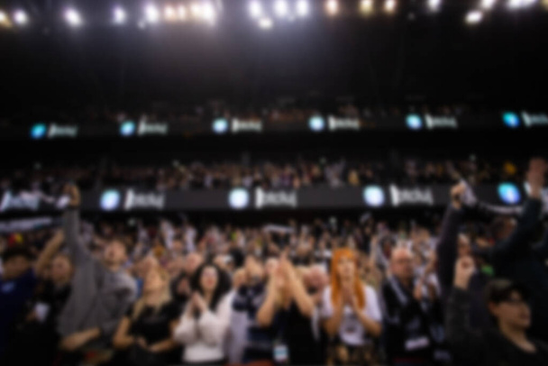 blurred background of supporters at sports event crowd of people in a basketball court - Photo, Image