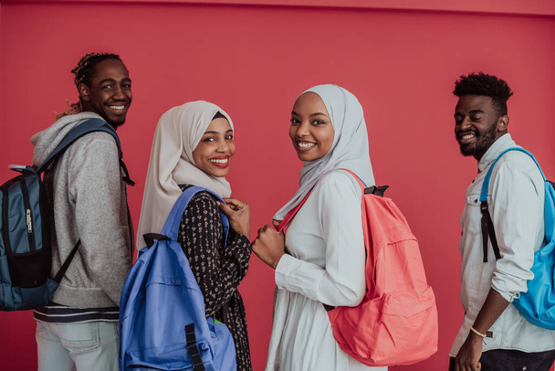 A group of African Muslim students with backpacks posing on a pink background. the concept of school education. - Foto, afbeelding