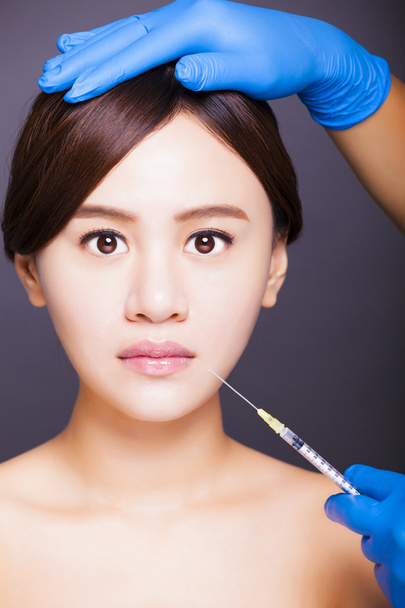 asian beautiful woman gets injection into her mouth. aesthetic m - Photo, Image