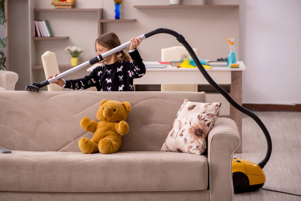 Young little girl doing housework at home - Foto, imagen