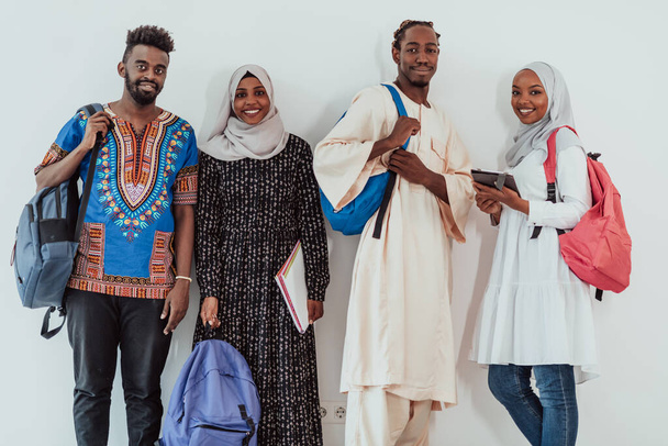 Photo of a group of happy african students talking and meeting together working on homework girls wearing traditional Sudanese Muslim hijab - Foto, Imagem