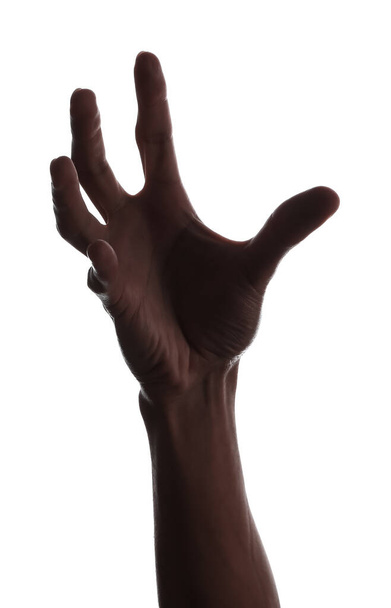 Silhouette di mano maschile che tiene qualcosa su sfondo bianco - Foto, immagini
