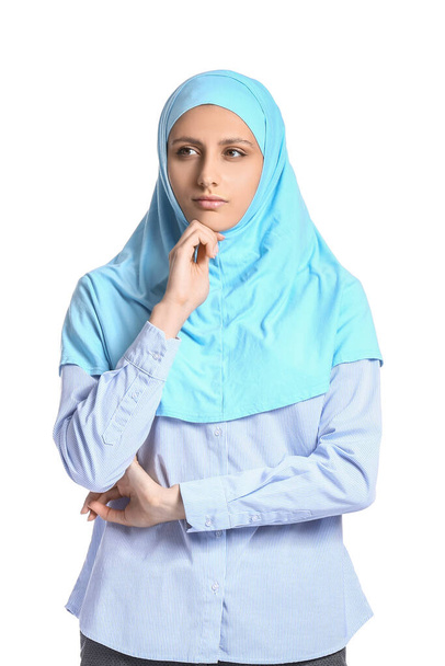 Portrait of thoughtful Muslim secretary on white background - Zdjęcie, obraz