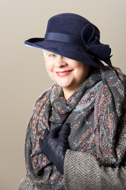 Smiling white-haired woman in hat and scarf - 写真・画像