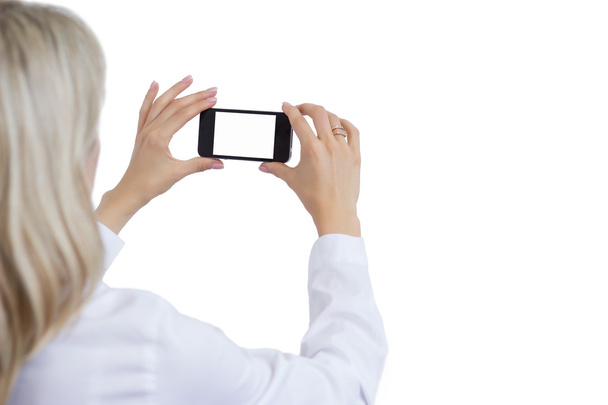 Femme prenant des photos avec un téléphone portable. Fond blanc isolé pour votre propre image
. - Photo, image
