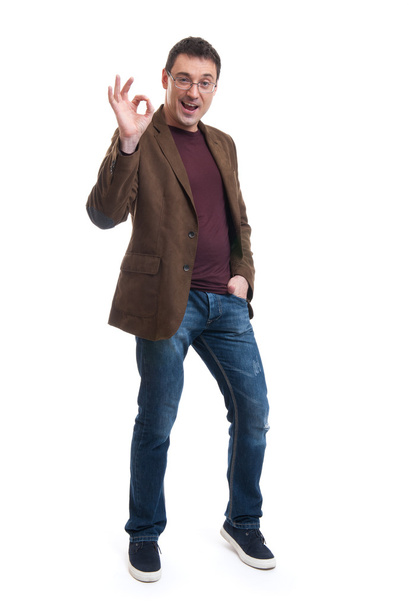 Happy young man gesturing OK sign - Foto, afbeelding