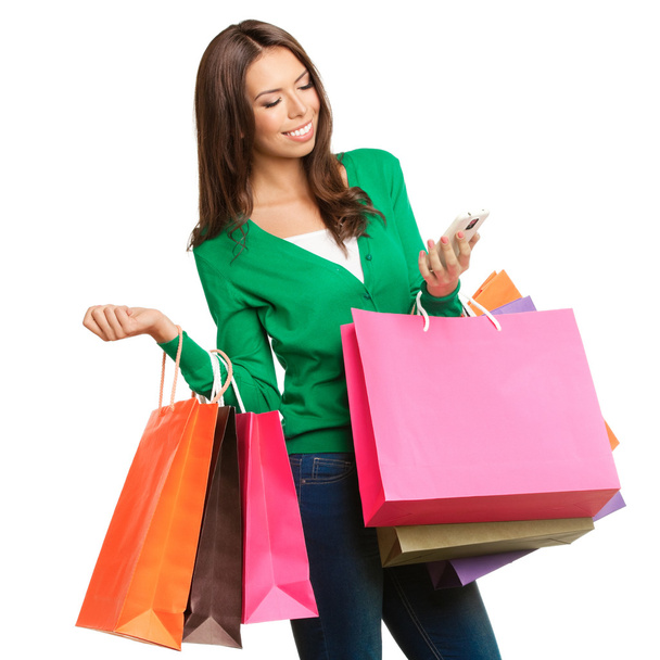 Young happy woman with shopping bags, isolated - Foto, imagen