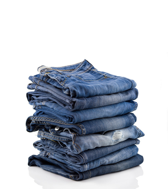 Stack of blue jeans on  white background - Foto, immagini