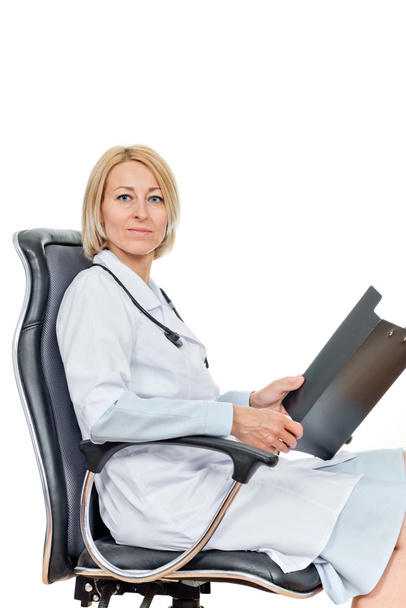 Successful doctor with stethoscope sitting in chair - Valokuva, kuva