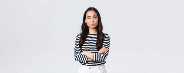 Lifestyle, beauty and fashion, people emotions concept. Confident smart businesswoman, asian female entrepreneur in casual clothes, cross arms chest and looking daring camera - Photo, Image